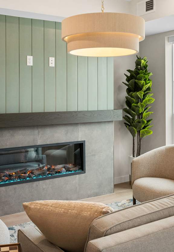 A living room with a fireplace and a couch at The Beaumont Apartments, Bozeman, 59715