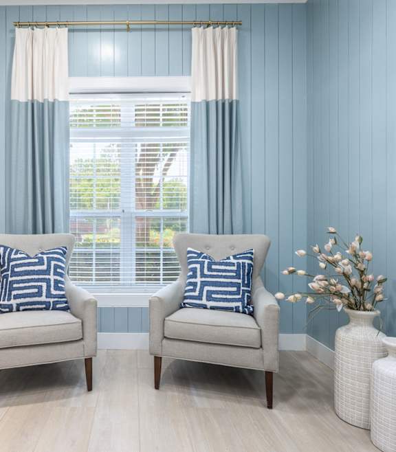 A modern living room with a stone fireplace and a large open space at Waterleaf at Neely Ferry Apartments, Simpsonville, SC