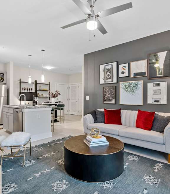 A modern living room with a grey carpet and a white sofa.at 198 Milltown Apartments, Burlington, 27215