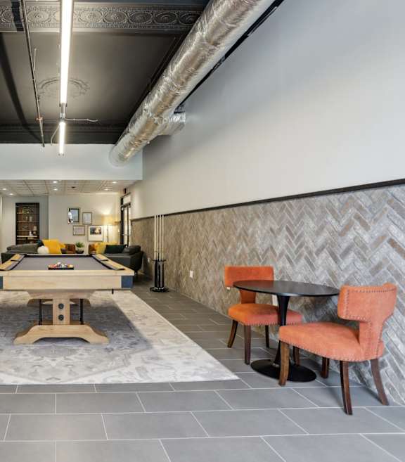 A wooden deck with a table and chairs at The Era Collective, St. Louis.