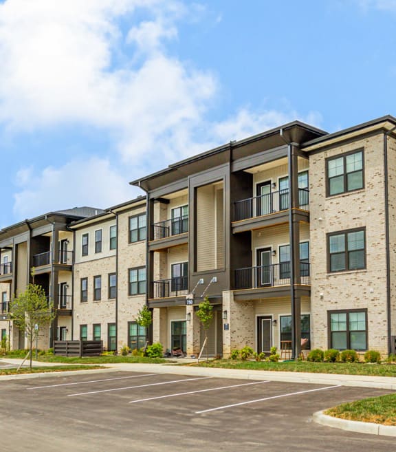 a parking lot in front of an apartment building