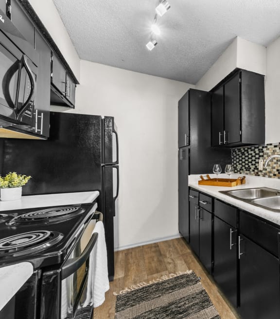a kitchen with a sink and a refrigerator at Vesper, Texas, 75254