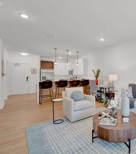 A living room with a white couch, a coffee table, and a rug.
