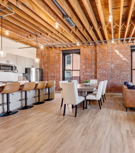 a living room and dining room with a table and chairs at Greeley Lofts, St. Louis, MO