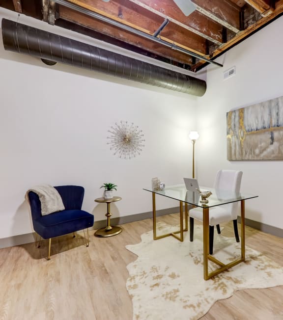 a conference room with a glass desk and a chair and a plant at Greeley Lofts, St. Louis, Missouri