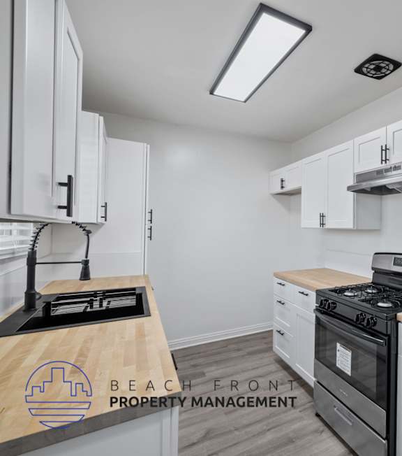A well-lit, modern kitchen and living room with a dining area.