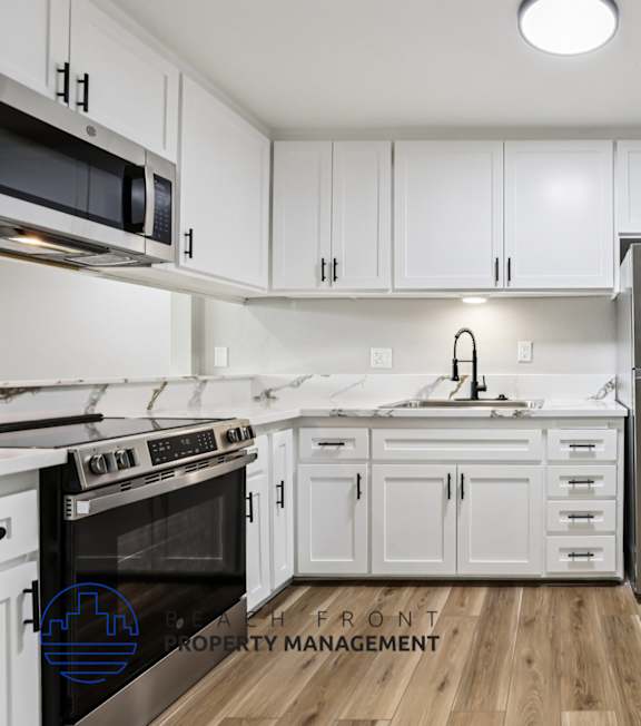 A well-lit, modern kitchen and living room with a dining area.