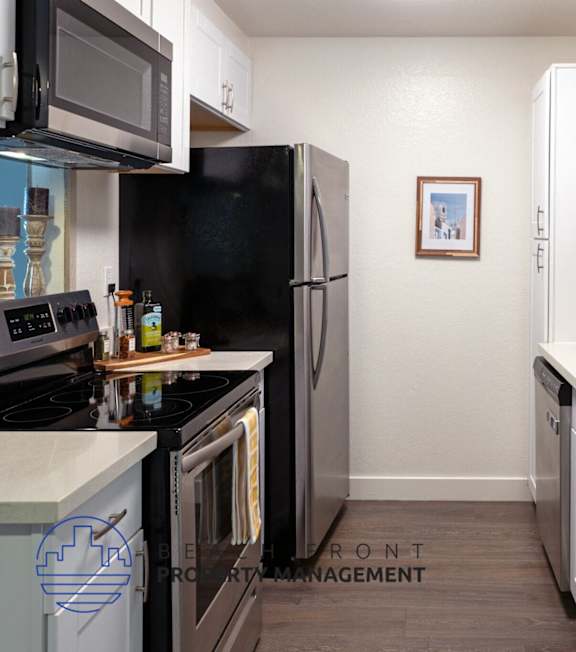 A well-lit, modern kitchen and living room with a dining area.