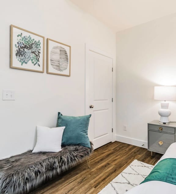 a bedroom with two beds and a nightstand with a lamp