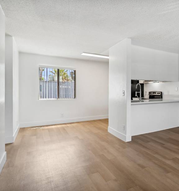A modern kitchen with a stainless steel refrigerator and a white countertop.