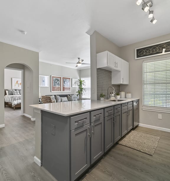 a kitchen with a large island and a dining room in the background