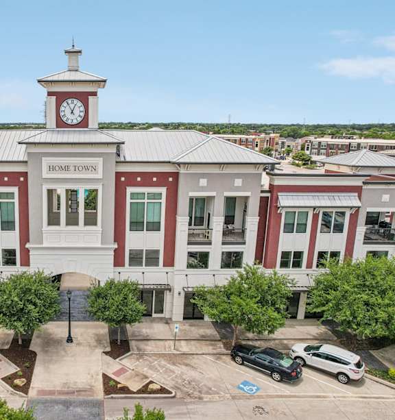 an aerial view of a building with a clock tower