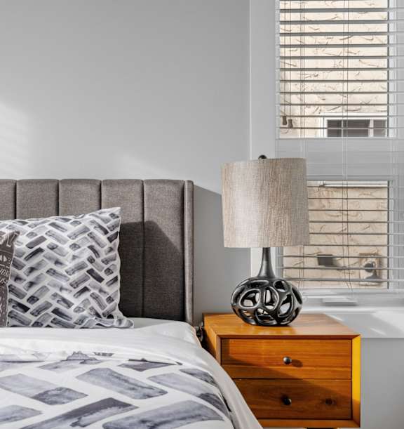 a bedroom with a bed and a ceiling fan