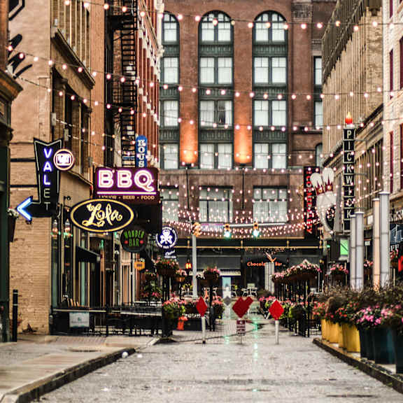 A street view of a city with a BBQ restaurant in the middle.