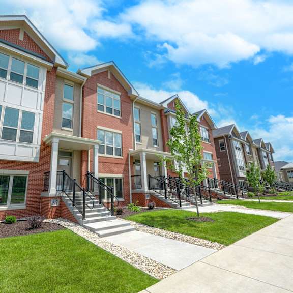 a row of brick row house in Middleton, WI with stairs and grass