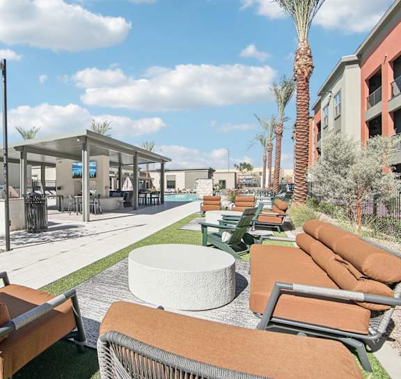 the pool is surrounded by palm trees and plants at The Maddox, Arizona
