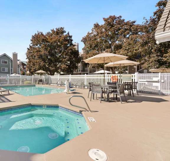 A pool with a hot tub and chairs. at AVIA Lofts on Parkway Apartments, Vancouver, 98662