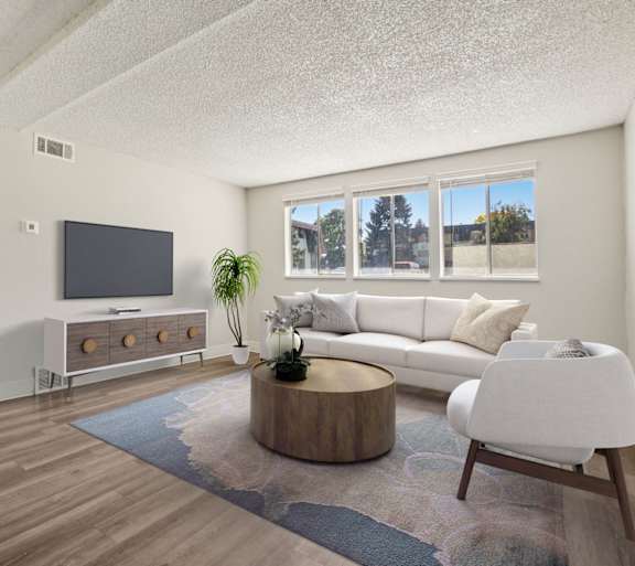 Dining area in a renovated Trailgrove apartment home with ceiling fan, bright windows, and open layout.