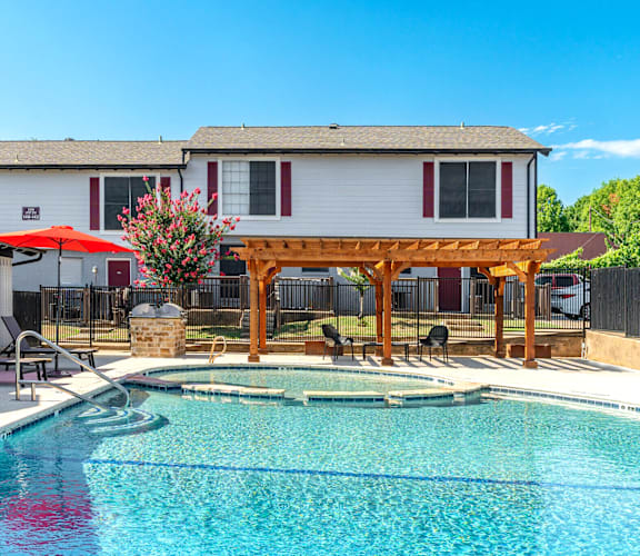 a swimming pool with a house in the background