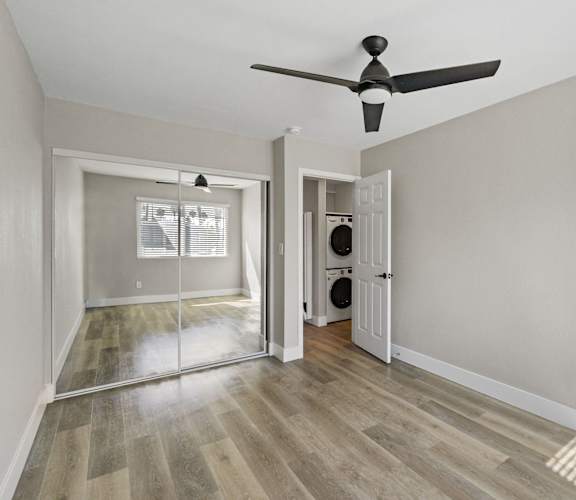 a living room with white walls and wood floors