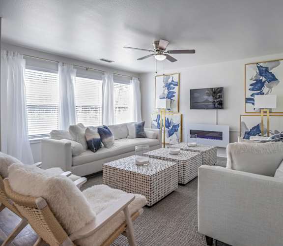 A living room with a white couch, a white chair, and a white coffee table. at Estates at Palm Bay, Florida, 32547