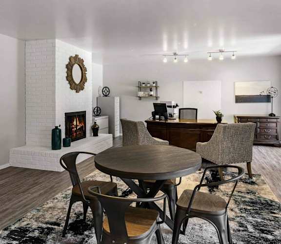 A modern dining room with a round table and chairs.
