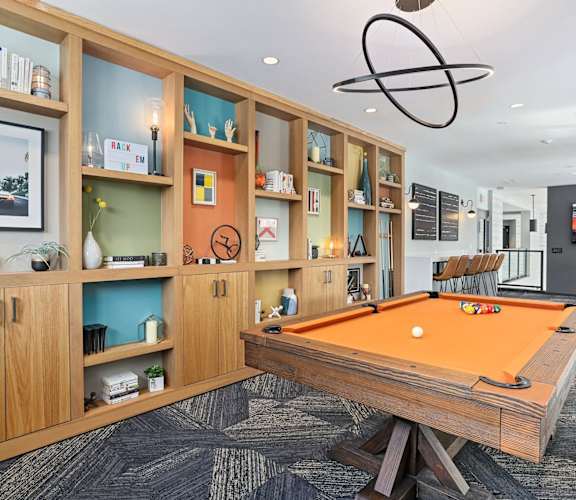 a games room with a pool table and a tv at Beekman on Broadway, Michigan, 48105