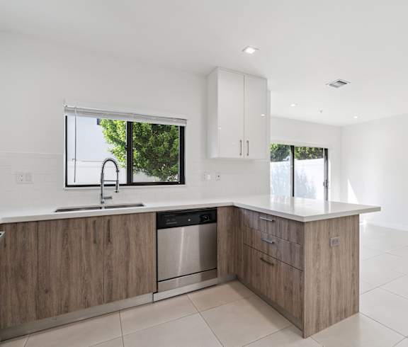 A modern kitchen with a sink and a window.at The Villages at Miami Gardens, 33056