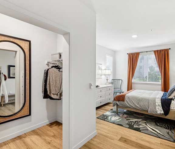 a bedroom with a bed and a dresser and a window