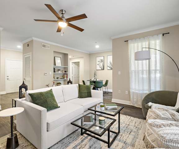 a living room with a white couch and a ceiling fan at The Verandah, Austin, Texas