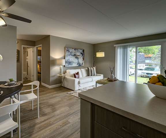 A modern kitchen and dining area with a table set for two.