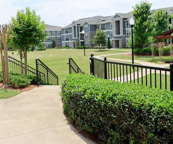 an apartment complex with a golf course in front of it at The Crest at Laurel Canyon, Canton, GA, 30114