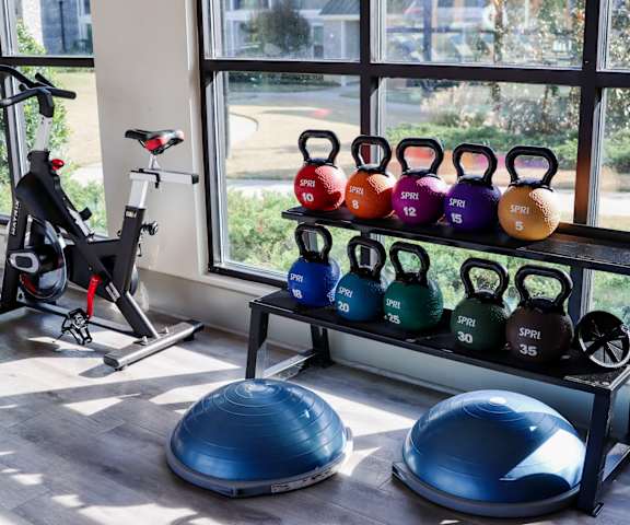 a home gym with weights and cardio equipment and a window at The Crest at Laurel Canyon, Canton