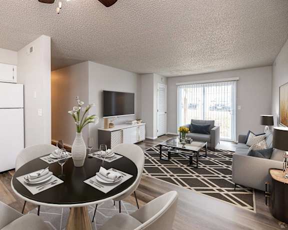 A modern dining room with a black table and chairs.at Fish Creek, Norwalk, IA 50211