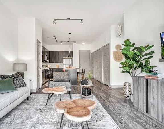 a living room with white walls and hardwood floors