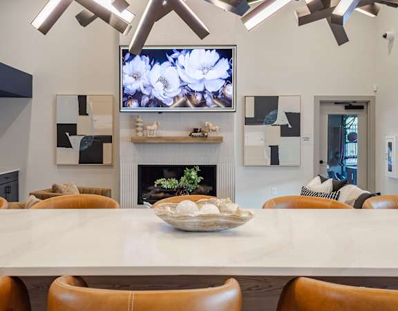 A modern dining room with a large table and chairs.
