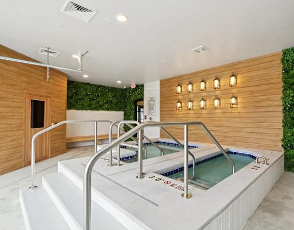 A hot tub in a room with a green wall.
