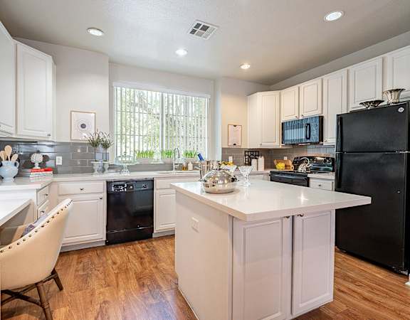 A kitchen with black appliances and white cabinets.at Palazzo Townhomes, Phoenix, AZ 85008