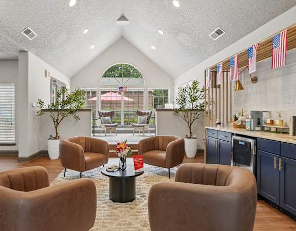 A living room with brown chairs and a white table.