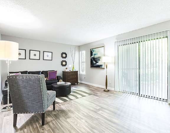a living room with white walls and hardwood flooring