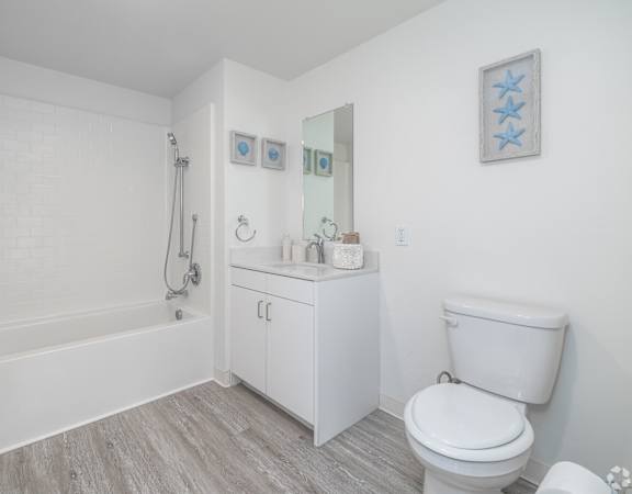 A white bathroom with a toilet, a sink, and a bathtub.