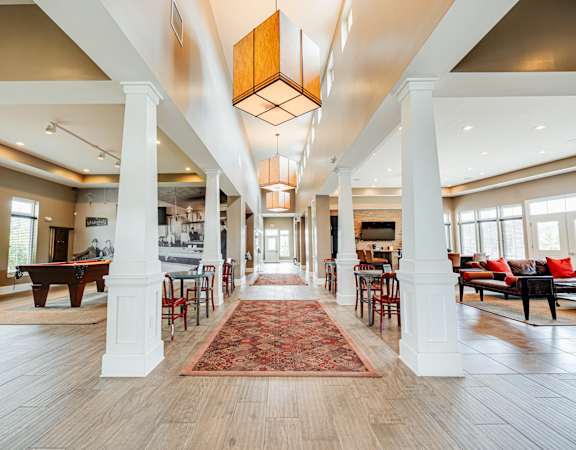 the preserve at cardinal courts spacious lobby with piano and tables