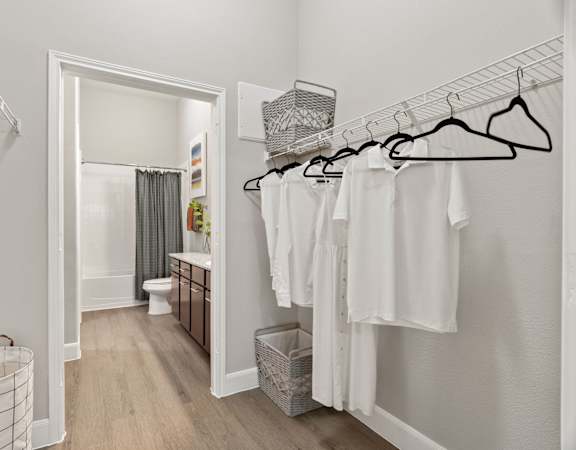 A laundry room with clothes hanging on a rack.