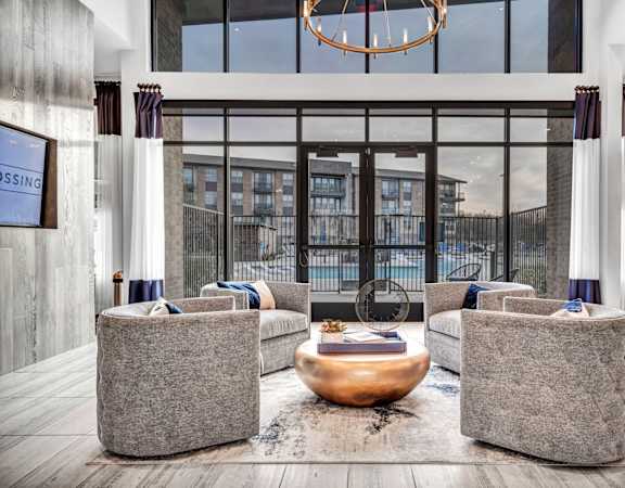 A modern living room with a fireplace and two grey couches.