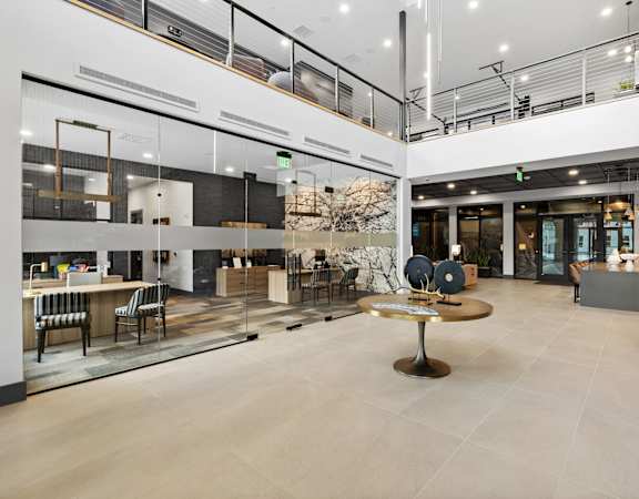 A modern open space with a central table and chairs.