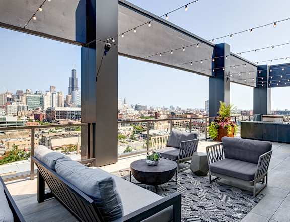 A rooftop patio with a view of the city skyline. at The Mason Apartments, Illinois, 60607