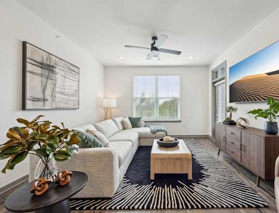a living room with a couch and a coffee table at The Quarry Luxury Apartment Homes, Fort Collins, Colorado