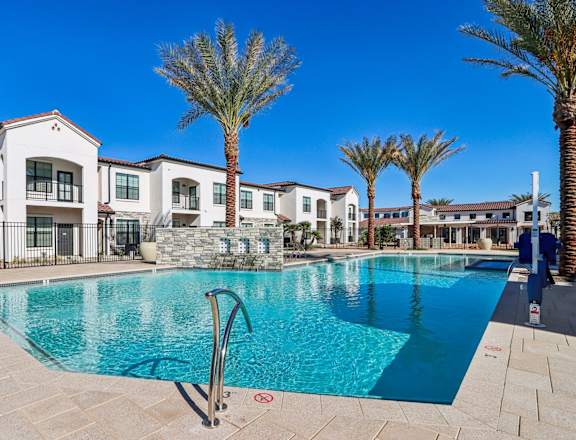 a swimming pool with apartments in the background at Stella Luxury Apartment Homes, San Tan Valley, AZ, 85143