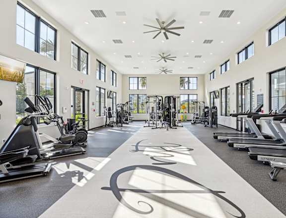 A gym with treadmills, elliptical machines, and a rowing machine  at Drift, Daytona Beach, FL, 32117