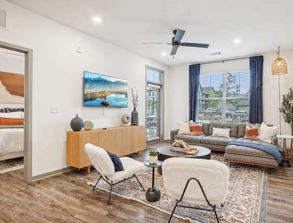 a living room with a couch and a chair and a ceiling fan at Notch66, Longmont, Colorado
